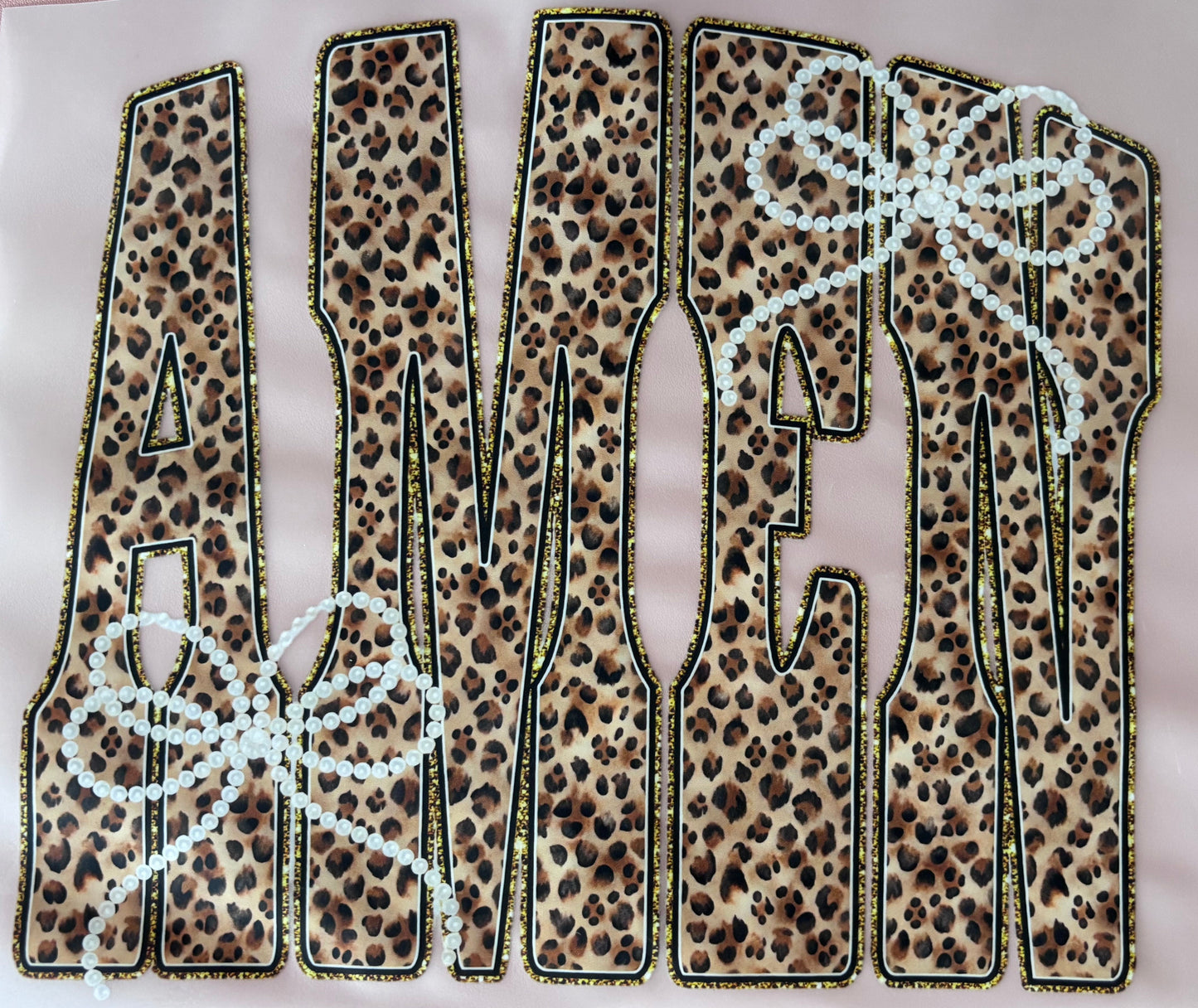 Leopard print letters spelling 'AMEN' on a dtf transfer tshirt tote bows