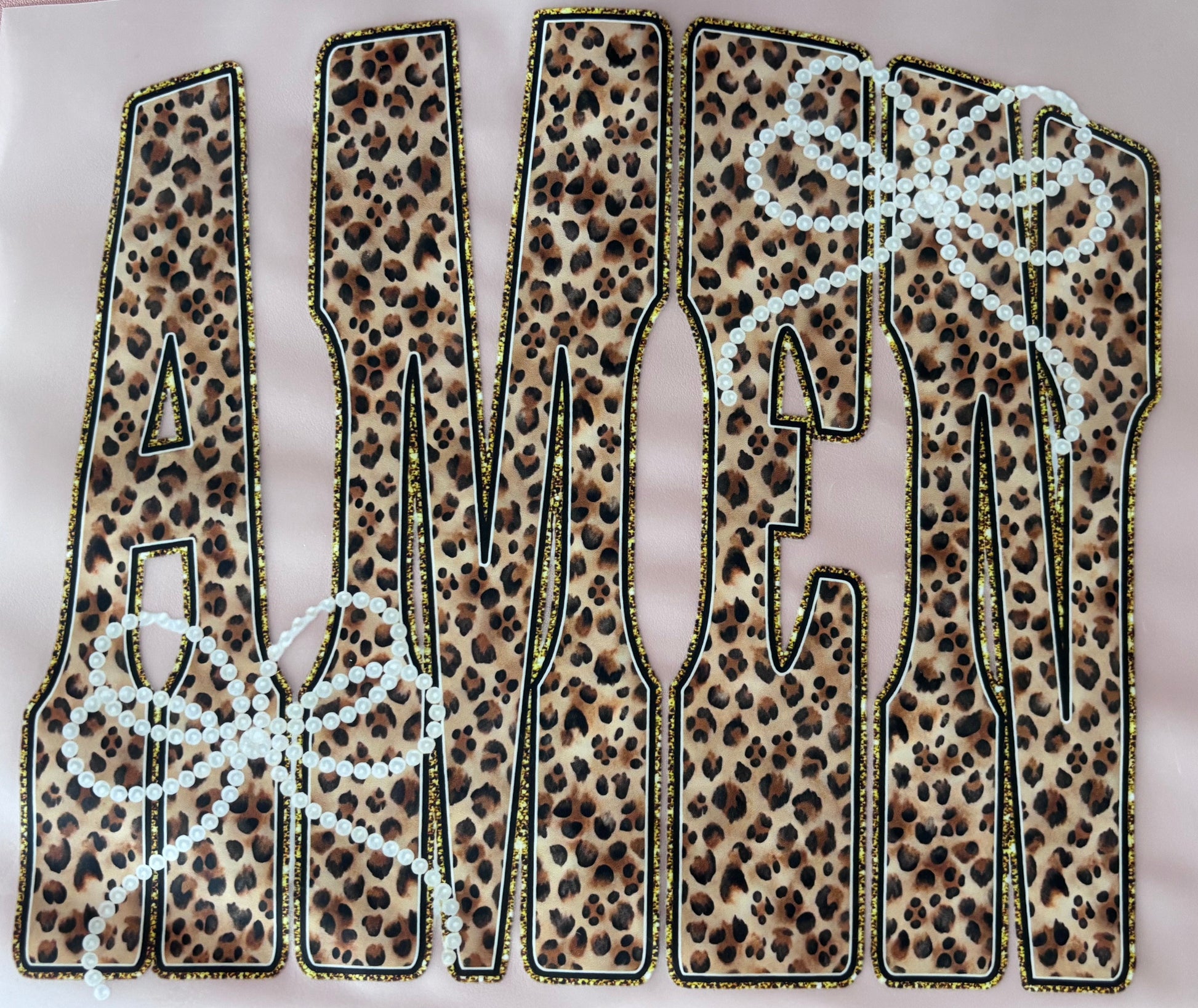 Leopard print letters spelling 'AMEN' on a dtf transfer tshirt tote bows