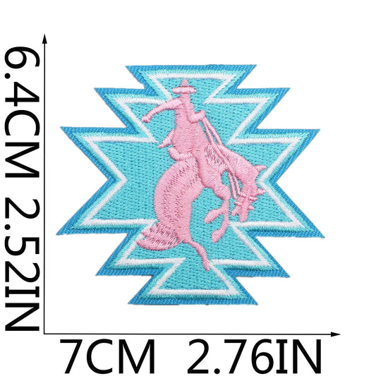 Embroidered patch with pink horse design on a blue geometric background, with measurements indicated. western cowgirl