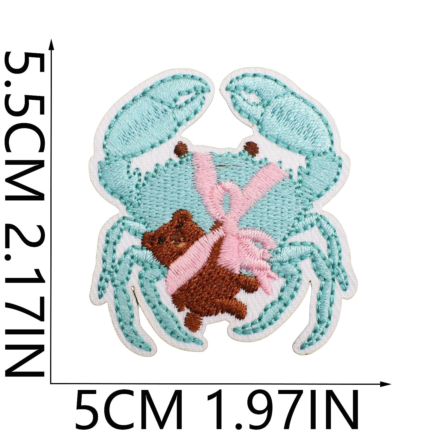 Embroidered patch of a crab holding a teddy bear with dimensions indicated. coastal cowgirl western